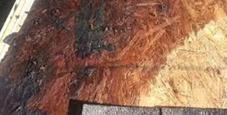 A close up of a piece of wood with a lot of stains on it.