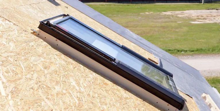 A skylight is sitting on top of a roof.