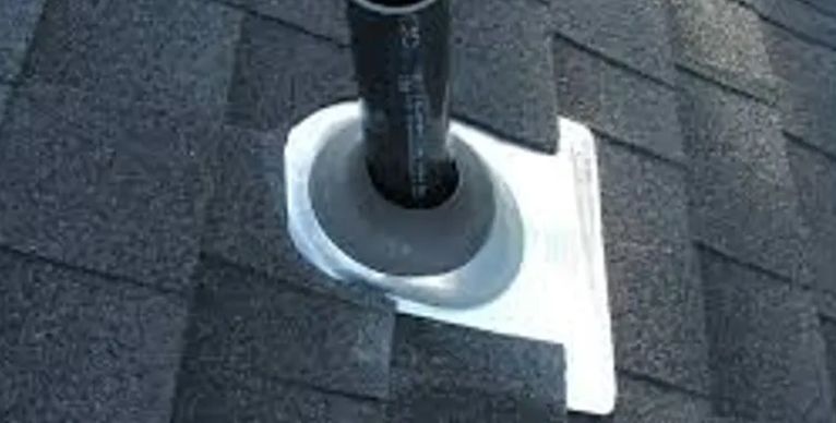 A pipe is sitting on top of a roof.