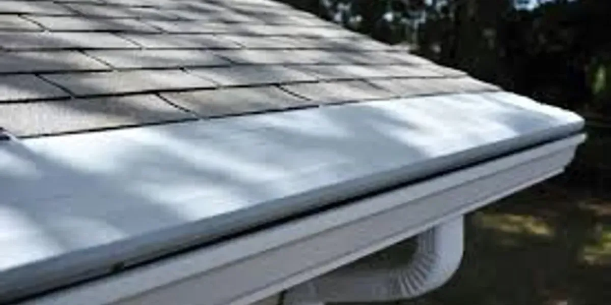 A close up of a white gutter on a roof.