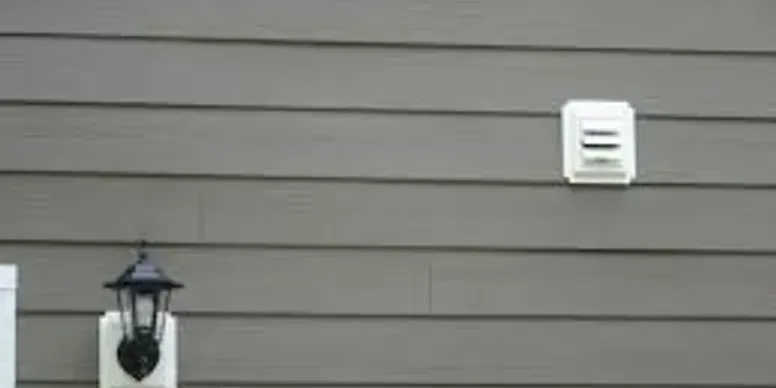 There is a lamp on the side of a house.
