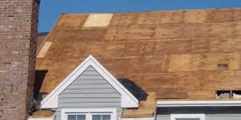 A house with a roof that is being repaired.
