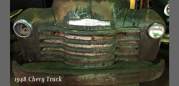 A close up of the front of an old chevy truck.