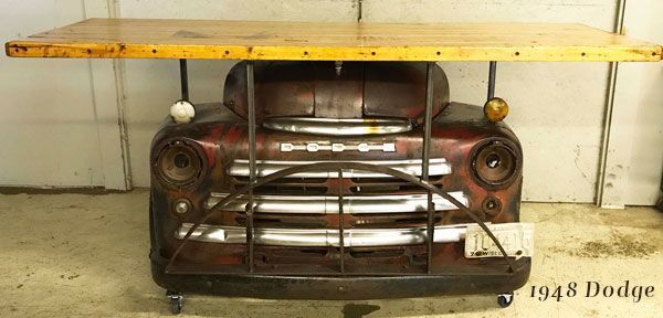 A table made out of the front of an old dodge truck