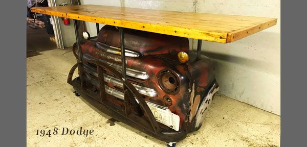 A table made out of the front end of a dodge truck.