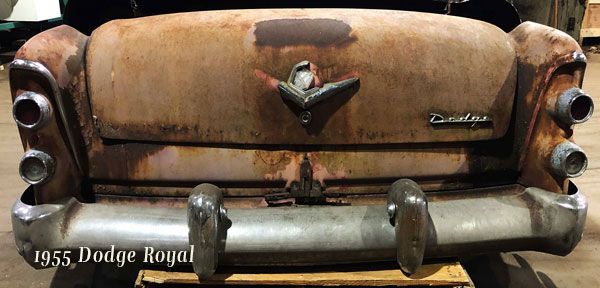 A 1955 dodge royal is sitting on a wooden pallet