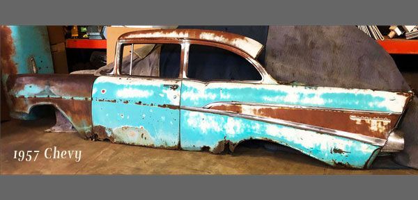 A rusty old car with the word chevy on the bottom