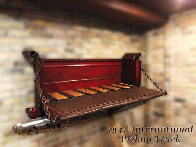 A 1948 international pickup truck is hanging on a wall
