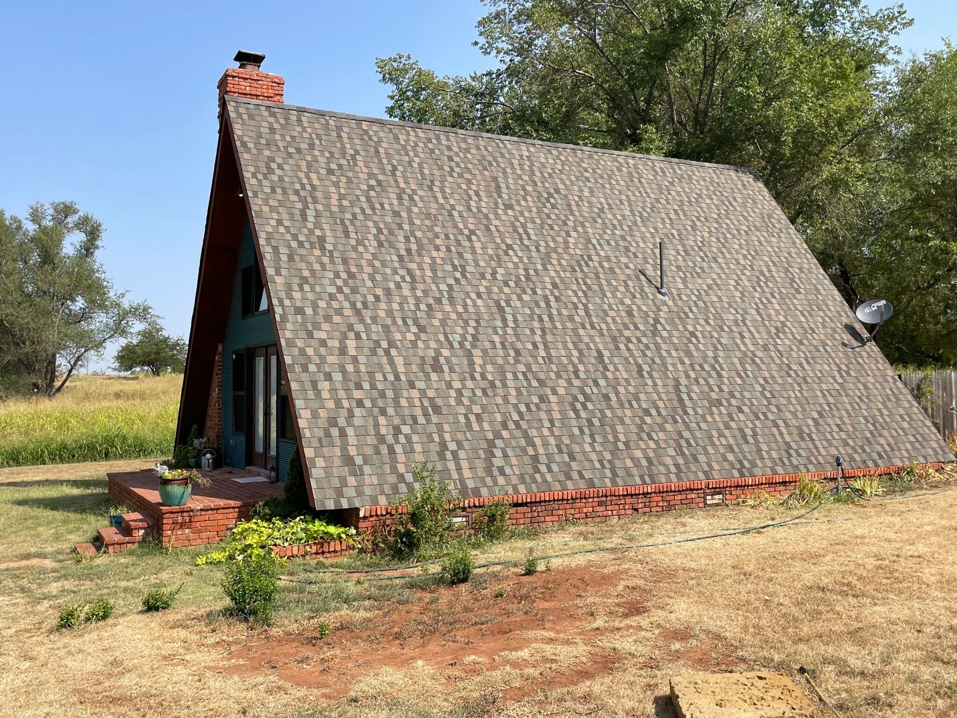 A small a frame house with a gray roof