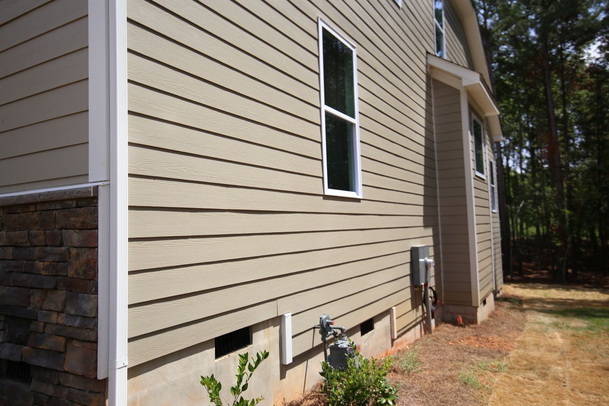 The side of a house with siding and a window