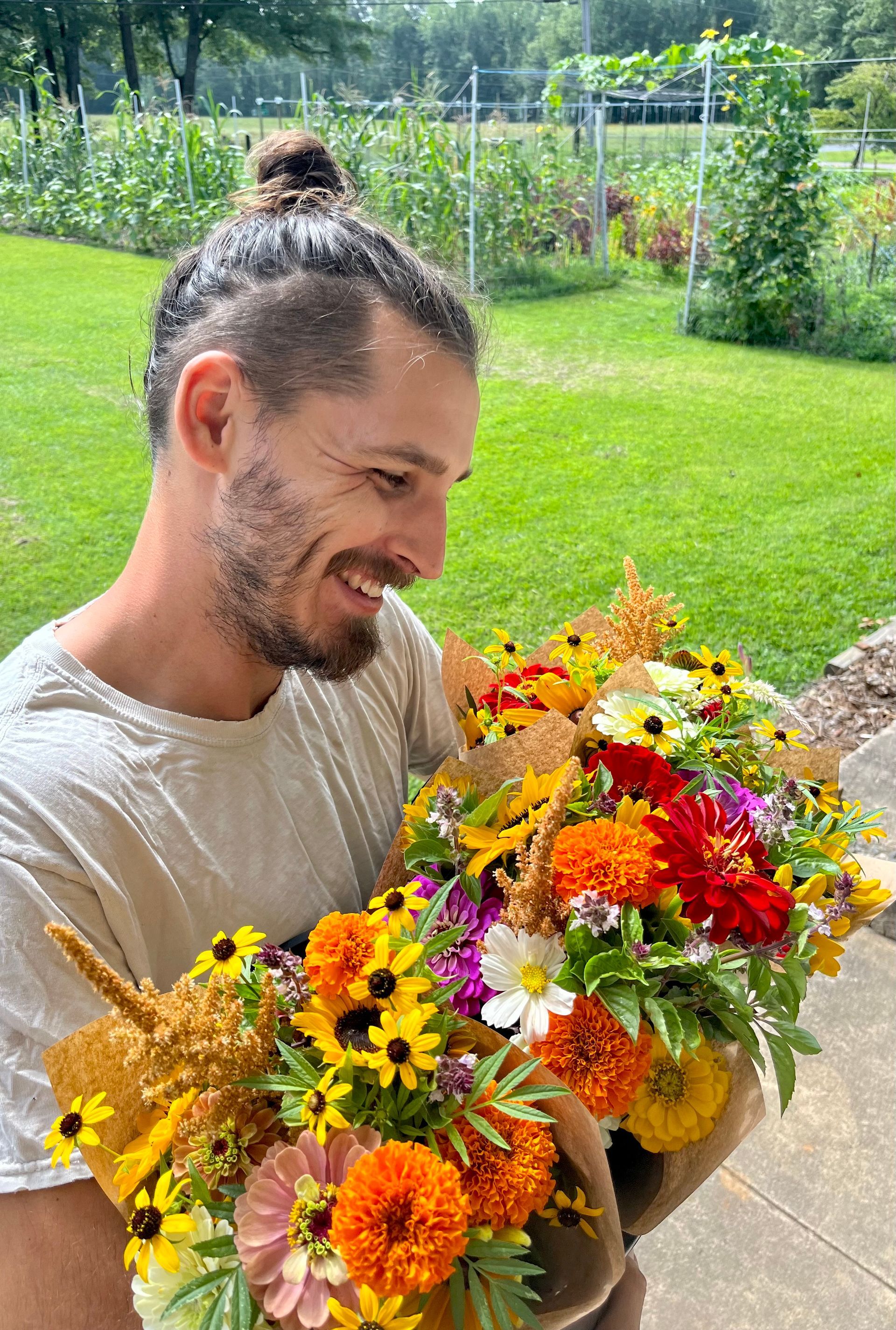A man is holding a bouquet of flowers in his hands.