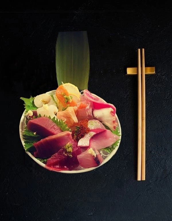 Colorful poke bowl with vegetables and chopsticks on a dark background