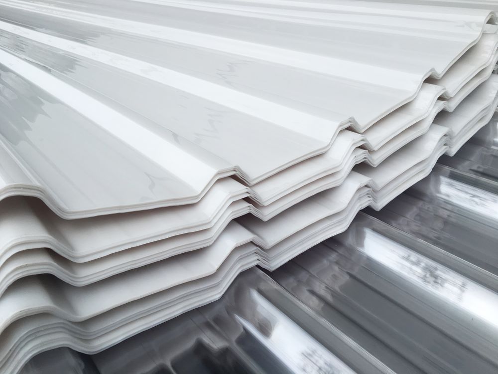 A Close Up of a Stack of White Corrugated Metal Sheets — Cairns Roofing Contractors Pty Ltd in Bungalow, QLD