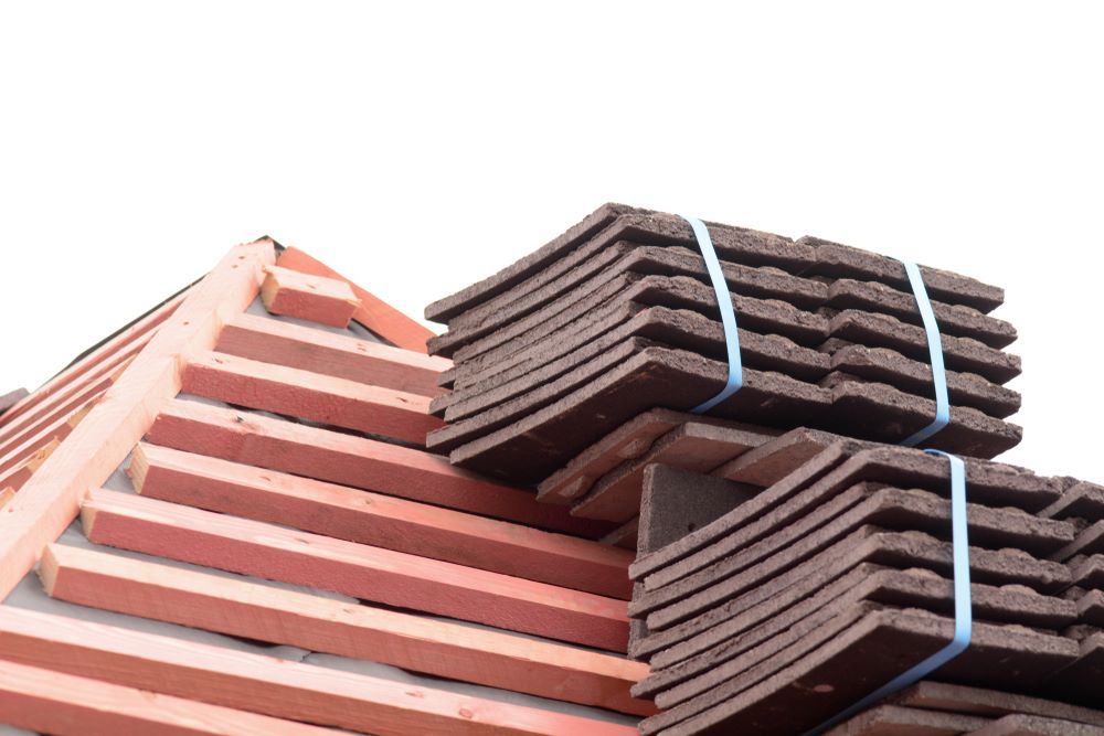 A Stack of Roof Tiles Sitting on Top of Each Other on a Roof — Cairns Roofing Contractors Pty Ltd in Bungalow, QLD