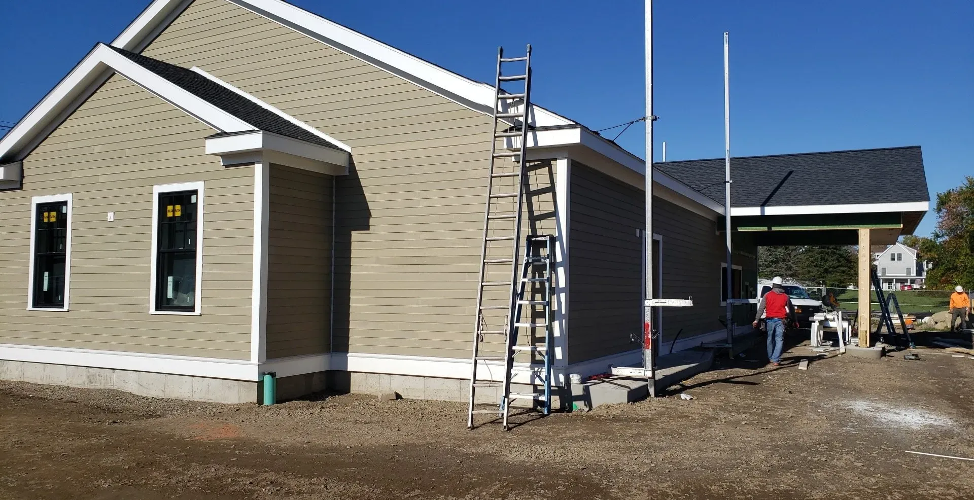 A house under construction with a ladder in front of it