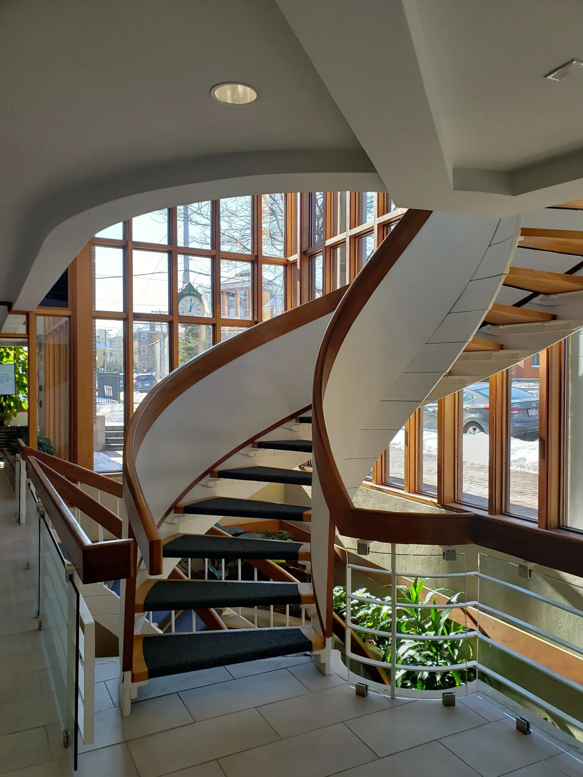 A spiral staircase in a building with lots of windows