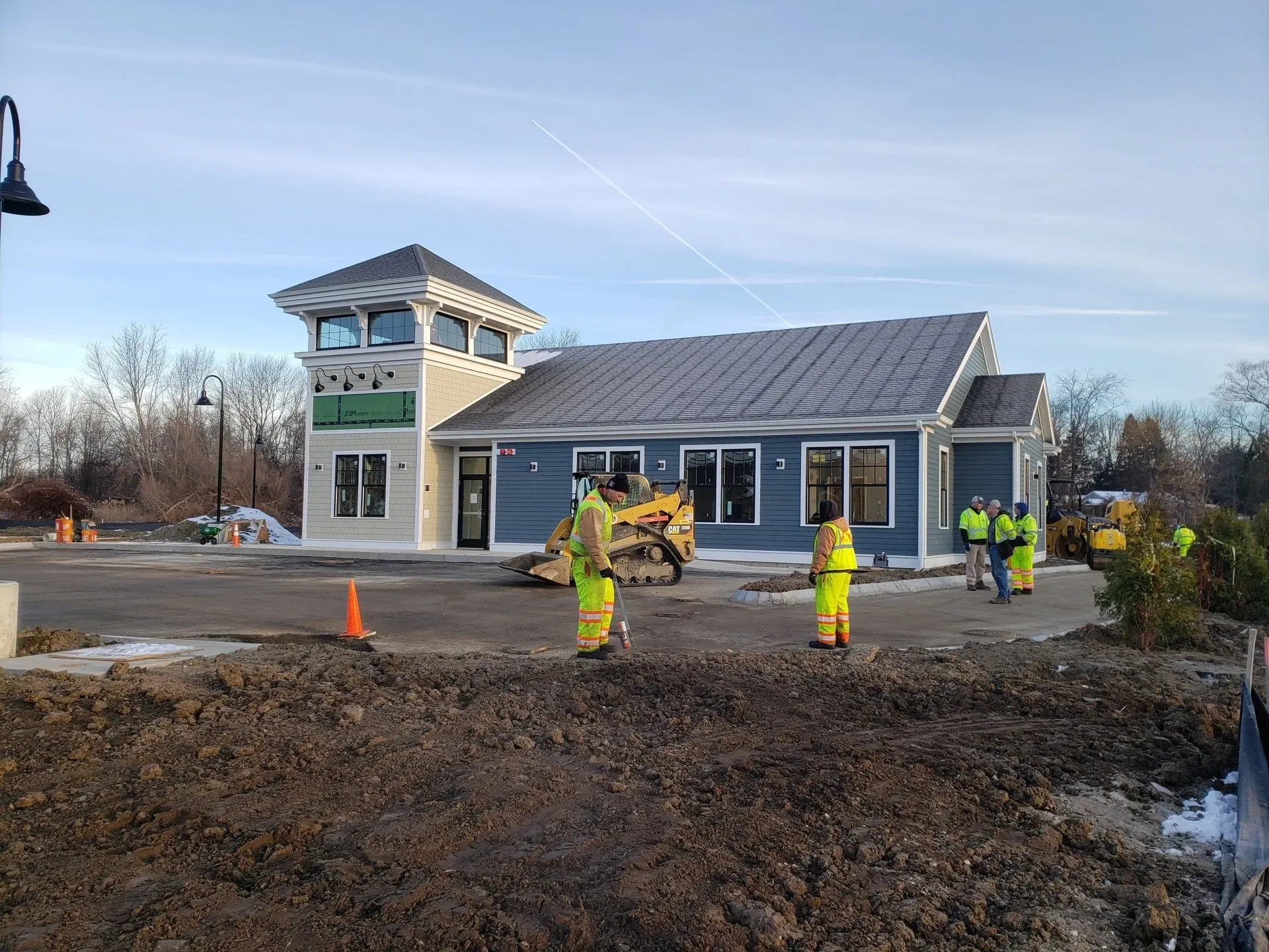 A group of construction workers are standing in front of a building.