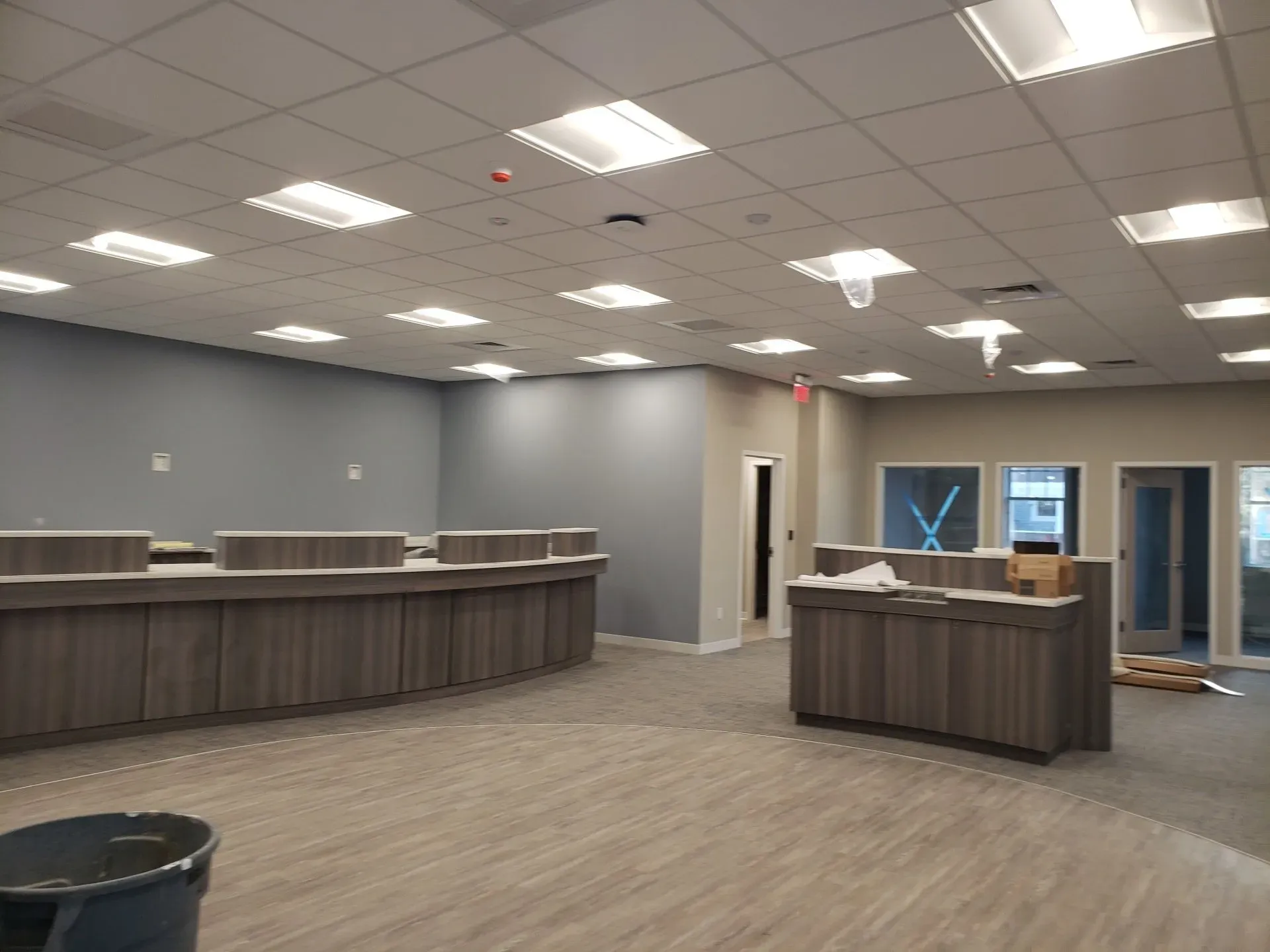 A large empty room with a lot of lights on the ceiling.
