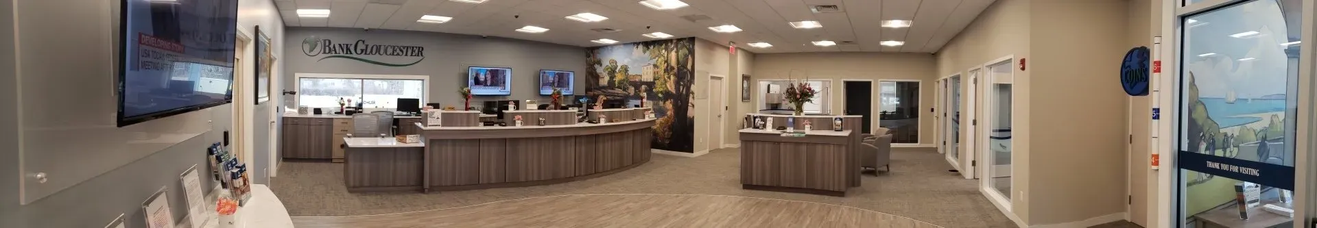 A blurry picture of a store with a lot of tables and a tv on the wall.