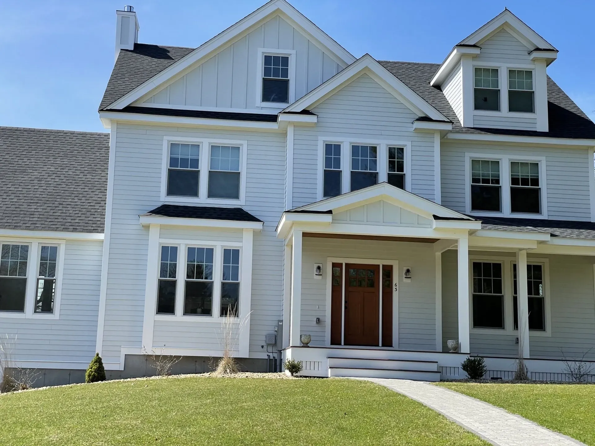 A large white house with a porch and a lot of windows