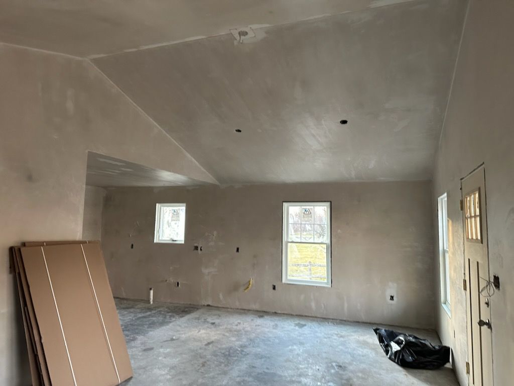 An empty room with a cardboard box on the floor