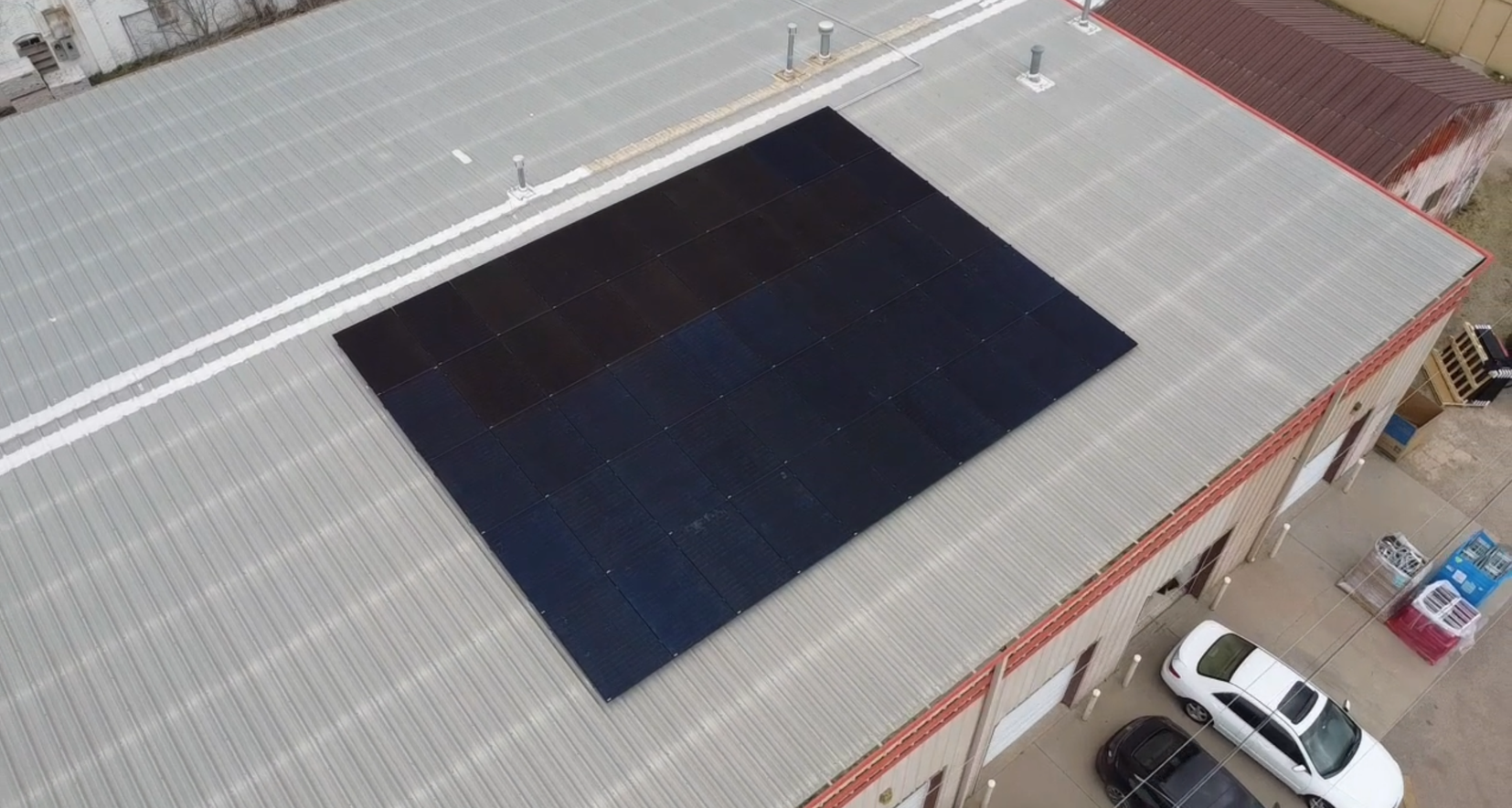Solar panels installed on the rooftop of a charming brick house, harnessing renewable energy from the sun to power the home.