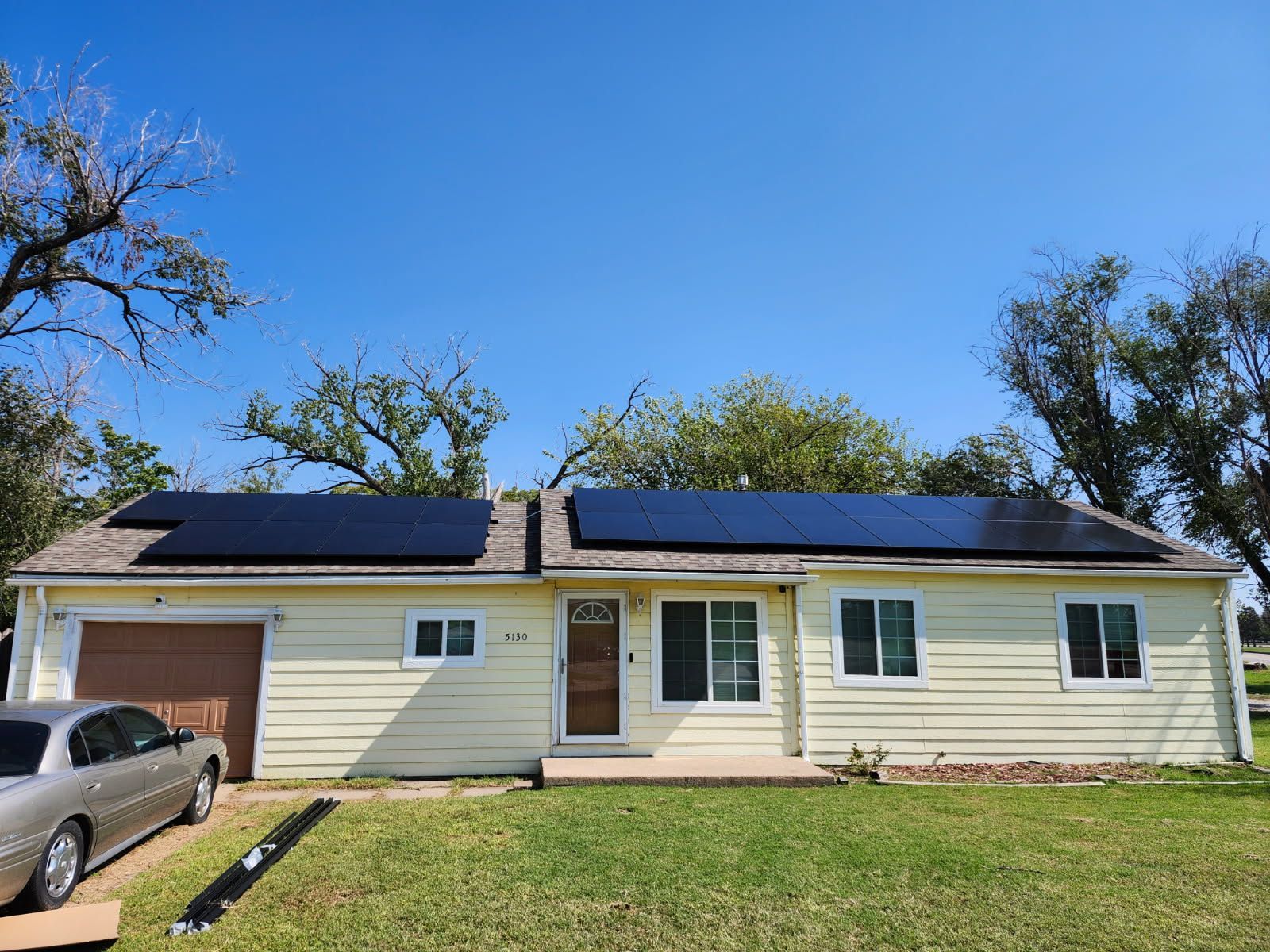 Solar panels installed on the rooftop of a charming brick house, harnessing renewable energy from the sun to power the home.