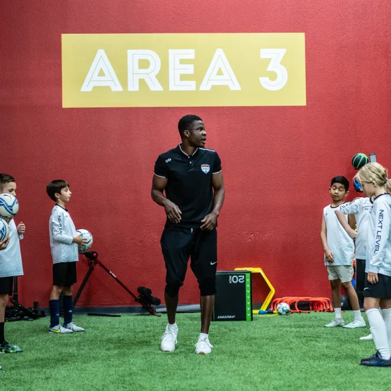 A man stands in front of a sign that says area 3