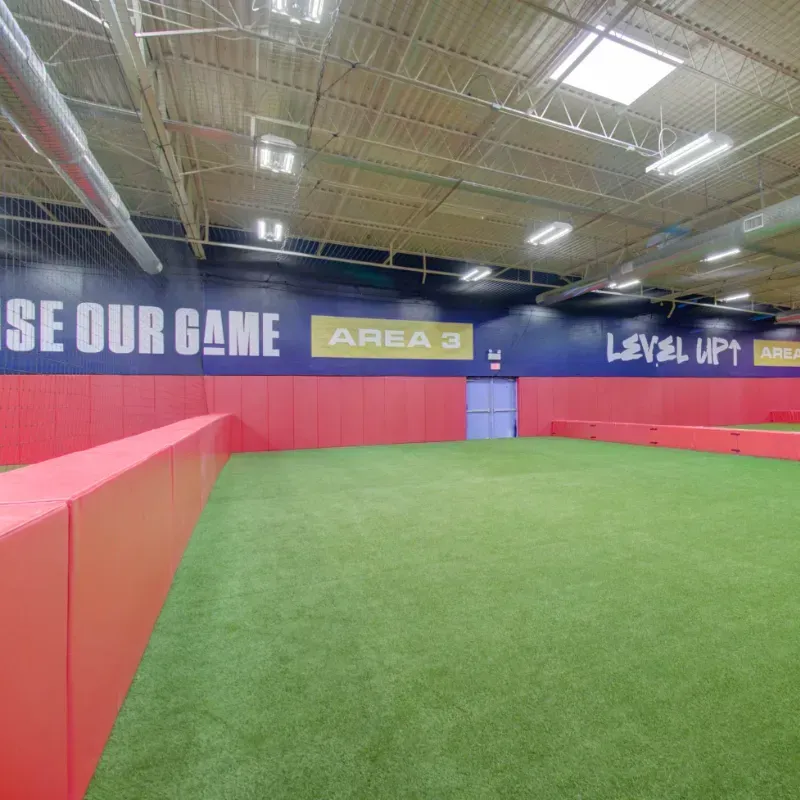 An indoor soccer field with a sign that says se our game