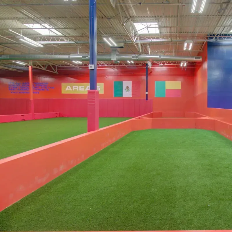 A soccer field in a building with a sign that says area