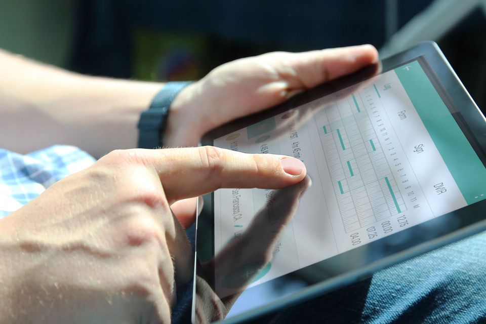 A Person Interacts with A Digital Graph on A Tablet Screen— Morisset Automotive in Morisset, NSW
