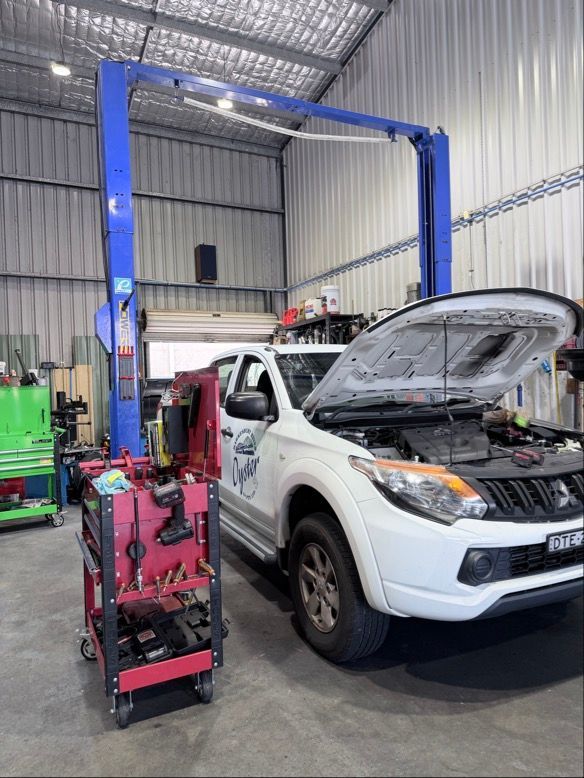 A White Pickup Truck with Its Hood Open Parked Inside an Auto Repair Shop — Morisset Automotive in Morisset, NSW