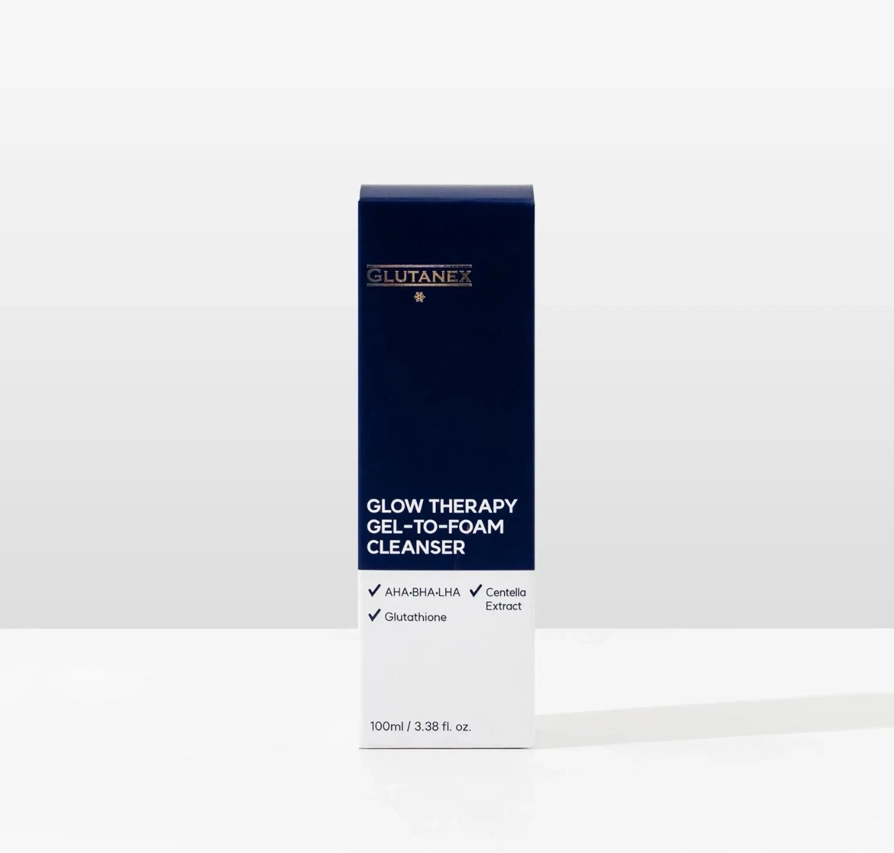 Blue-and-white cleanser box labeled “Glow Therapy Cell Cleanser” on a white background