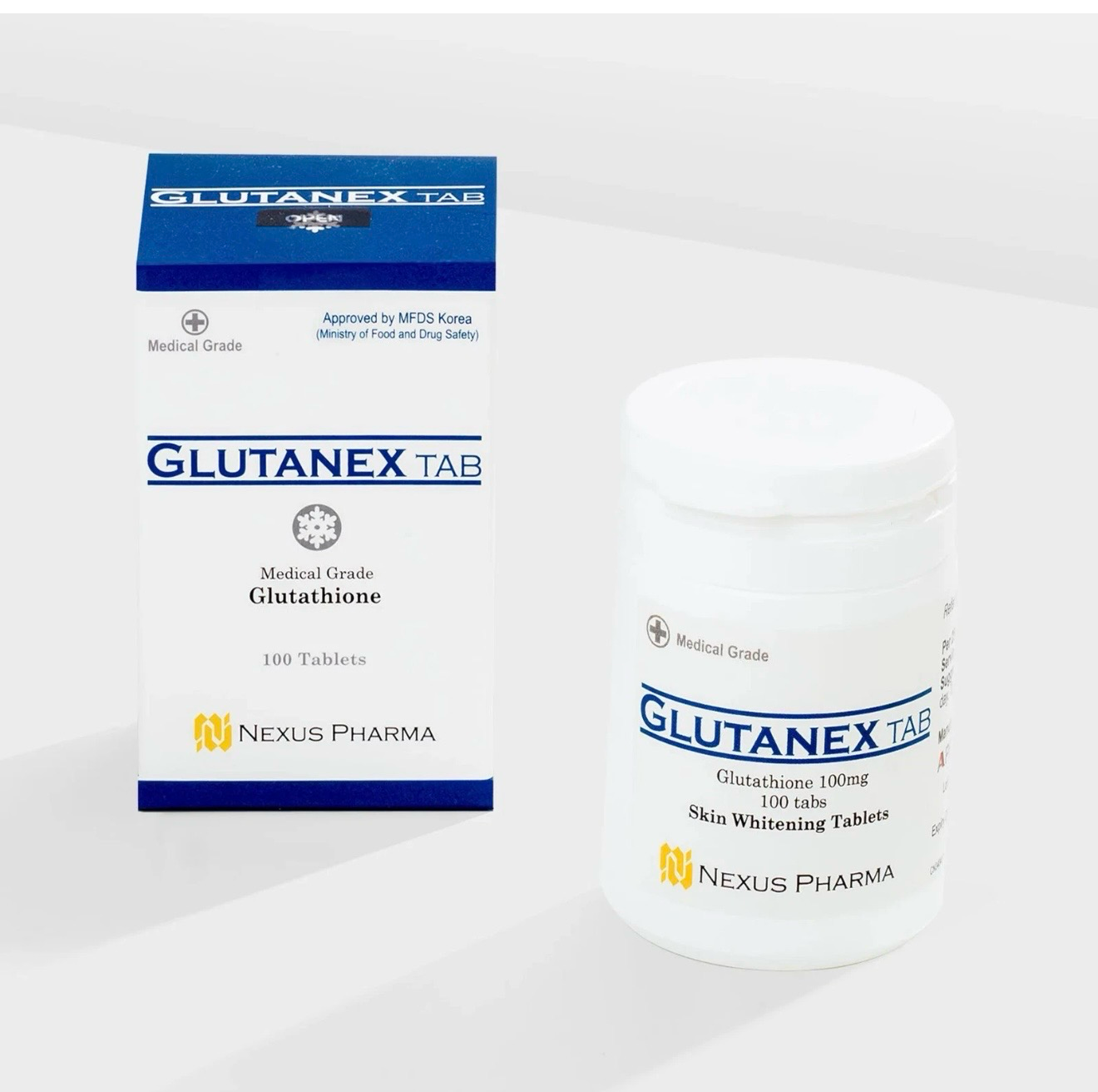 White bottle and blue-and-white box of GLUTANEX TAB tablets on a light background