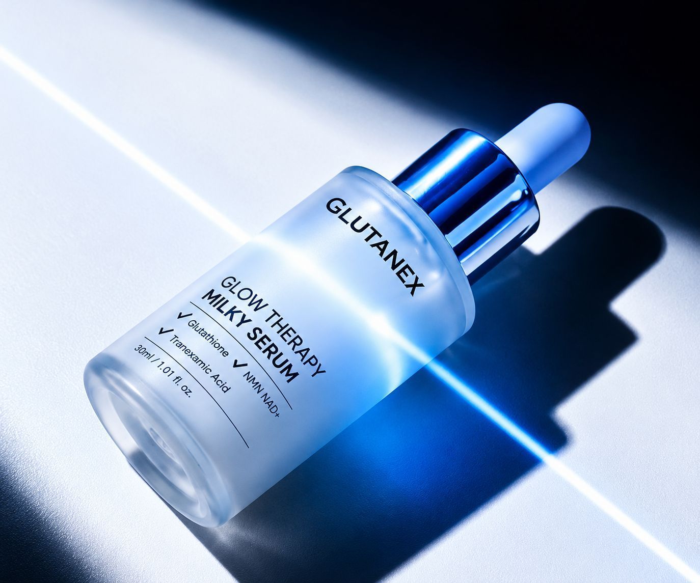 Glutamex serum dropper bottle on blue background with bright light beam