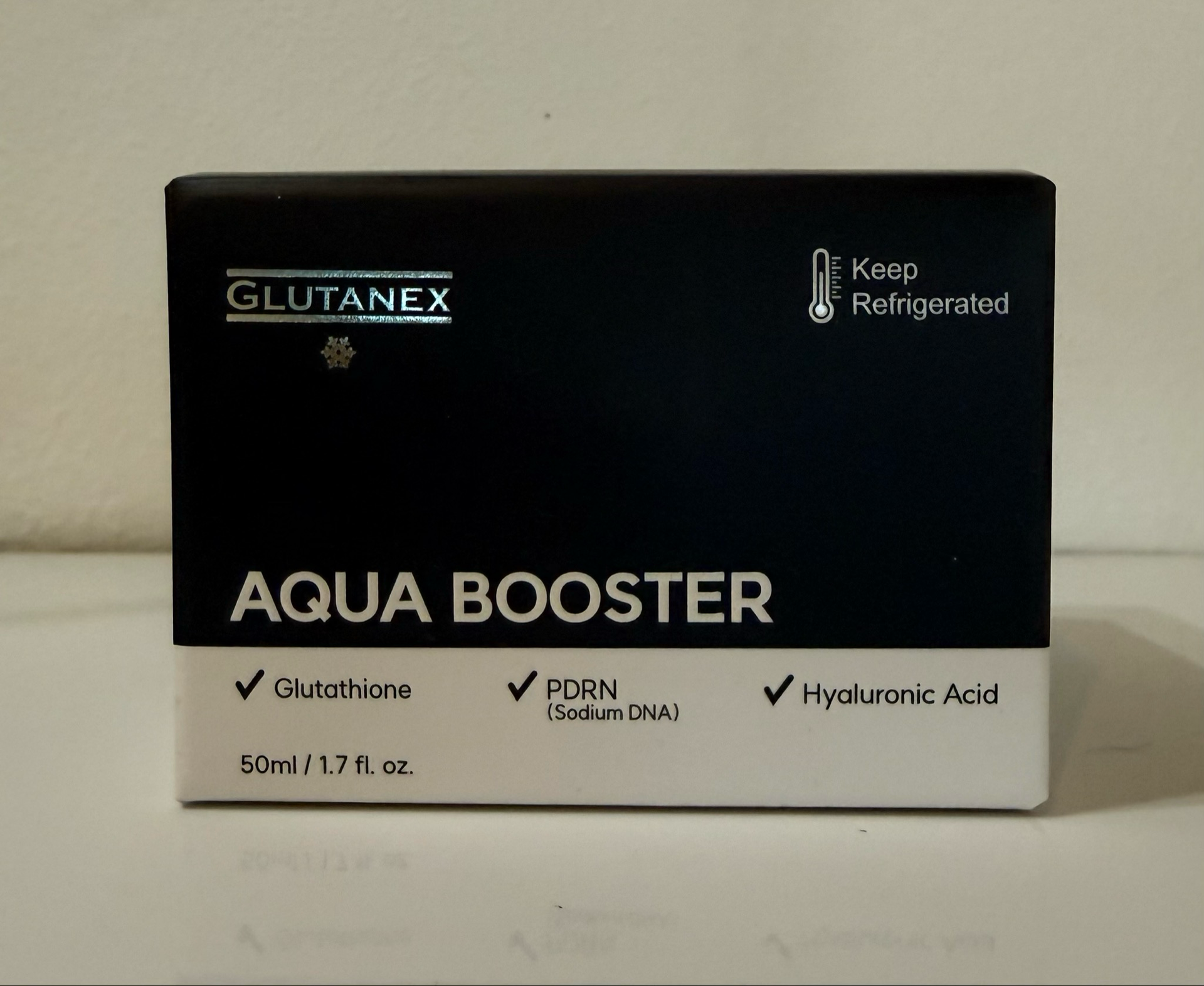 Black and white Glutanex Aqua Booster skincare box with label details and check marks