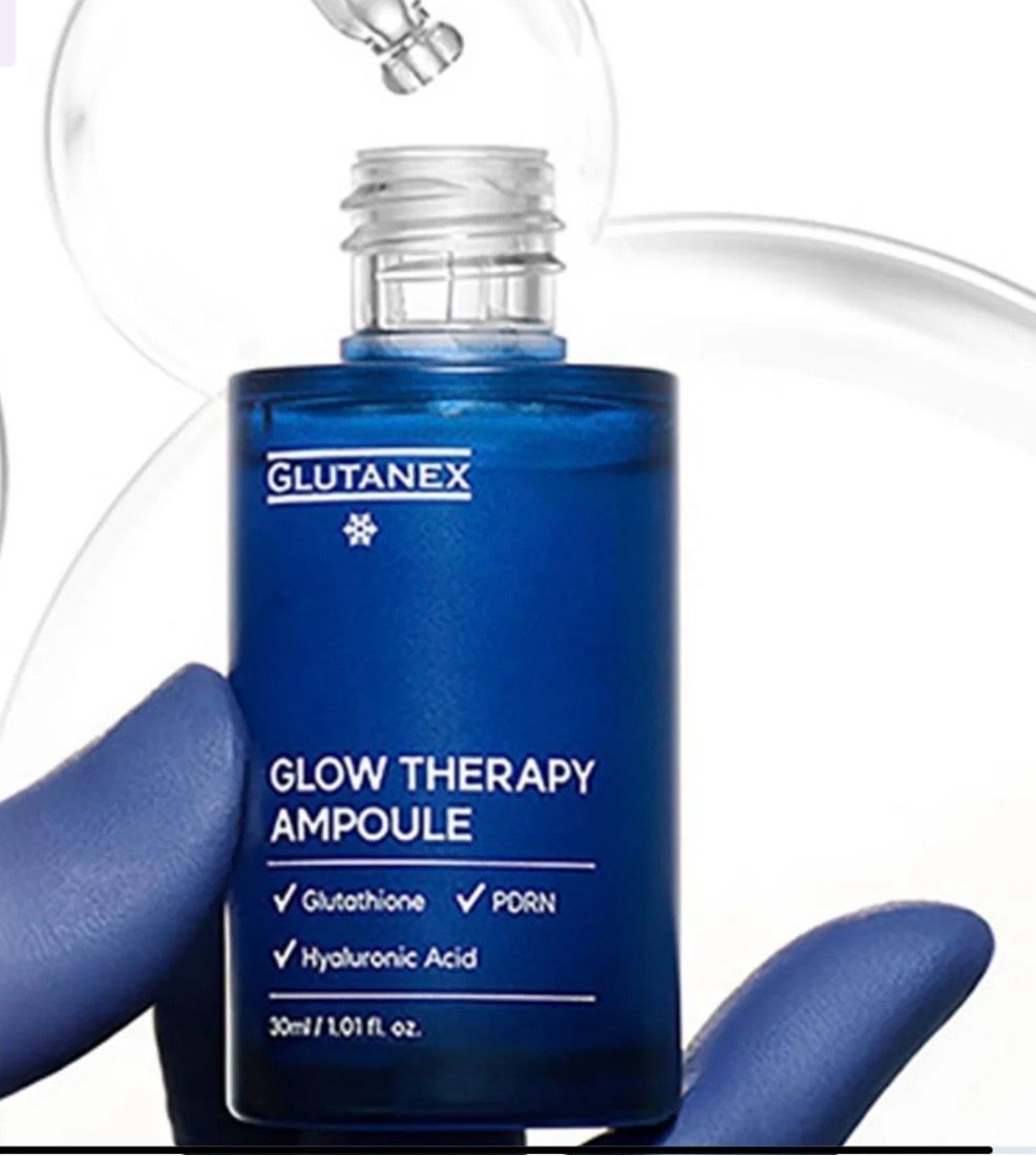 Blue GLUTANEX Glow Therapy Ampoule bottle with glass dropper and glove on white background