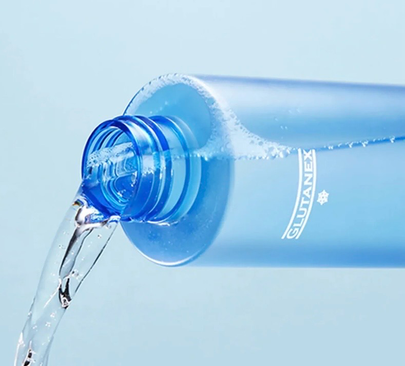 Blue water bottle pouring clear water against a light blue background
