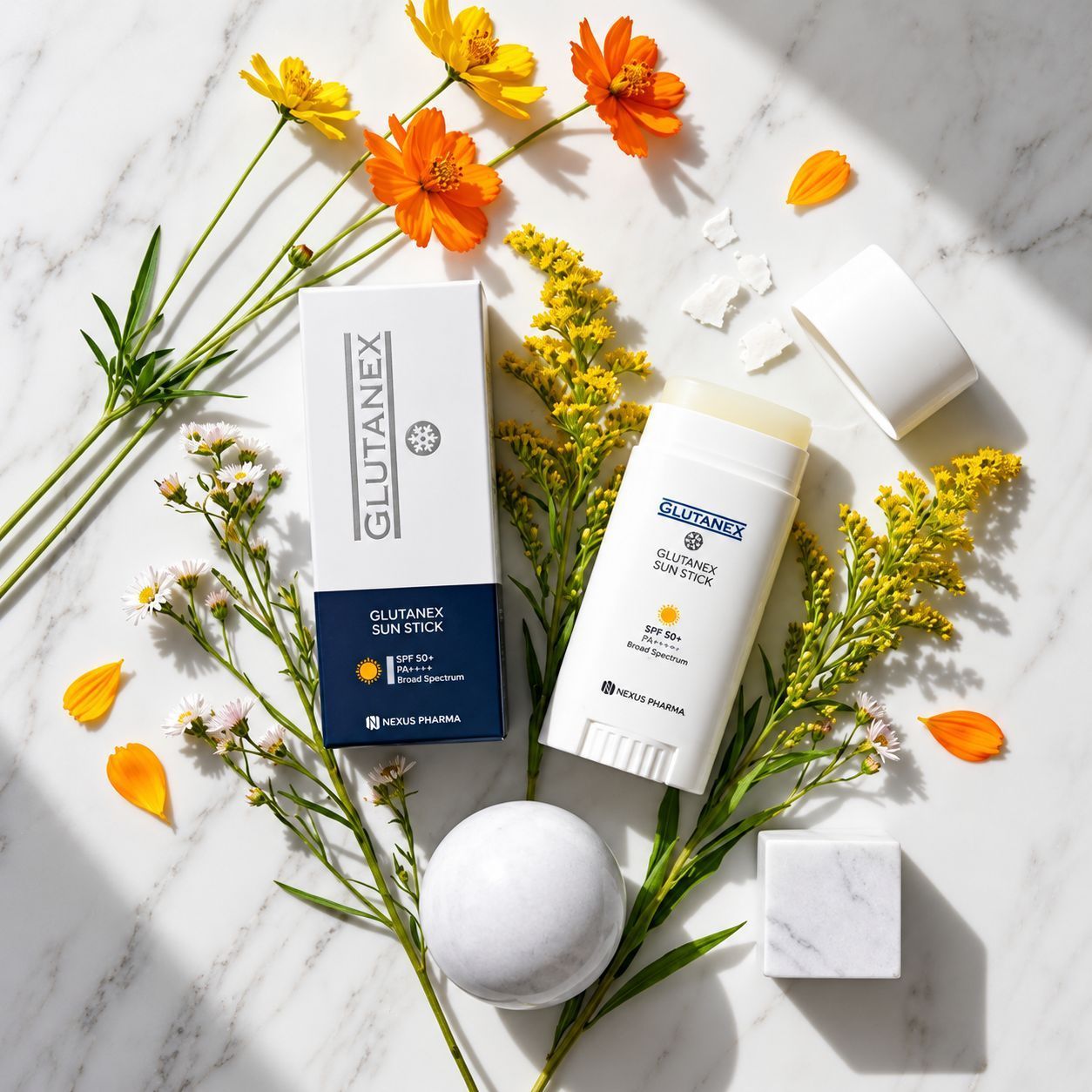 White skincare products with yellow flowers and orange petals on a marble surface.