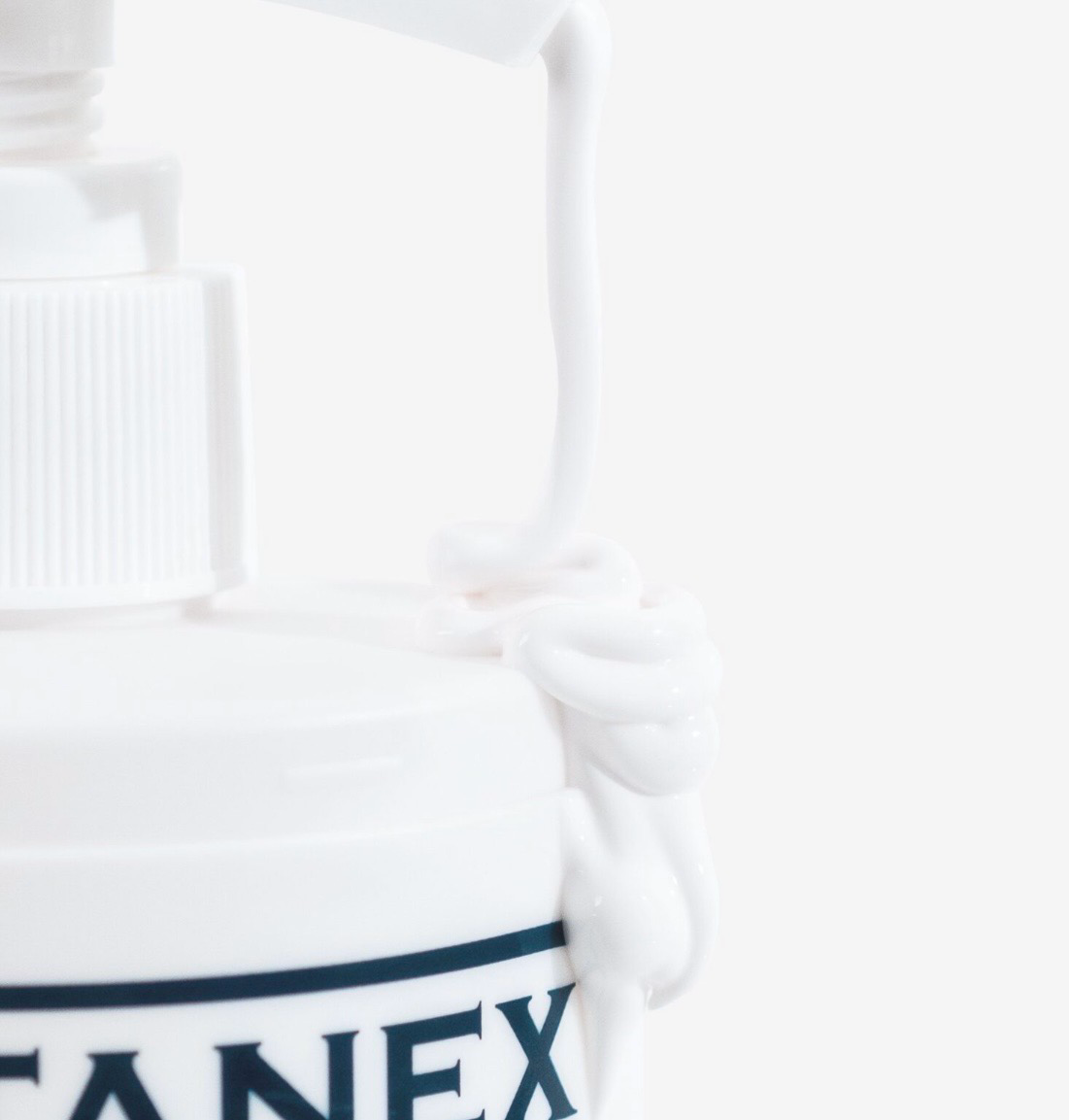 White product bottle with a pump and partial black label reading “ANEX”