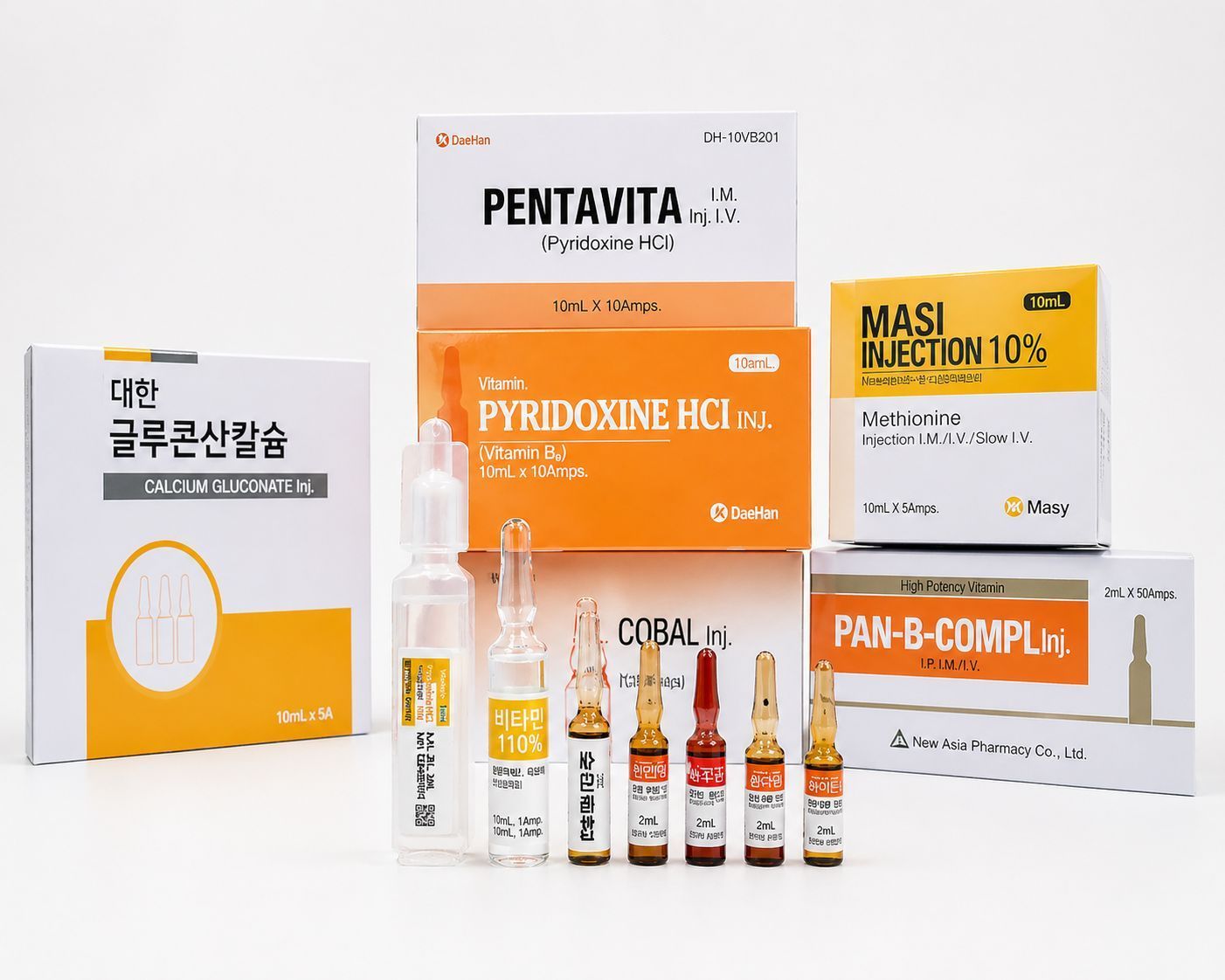 Assorted vitamin and supplement boxes and ampoules in white, orange, and yellow packaging arranged on a white background