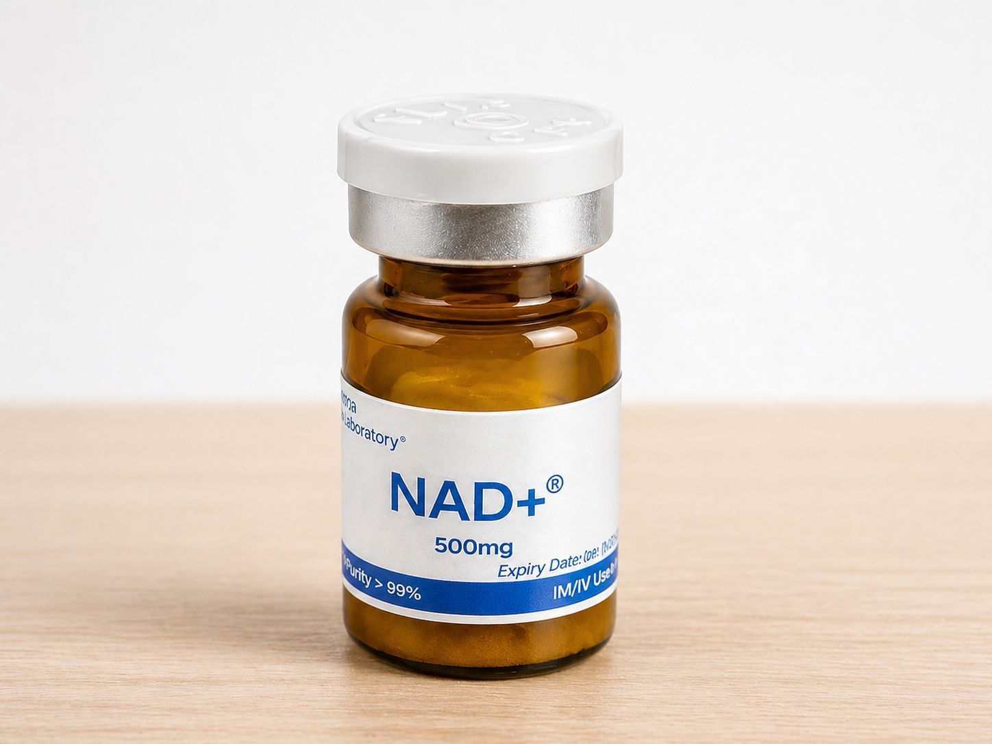Small amber vial labeled “NAD+ 100mg” with a white cap on a light wooden surface.