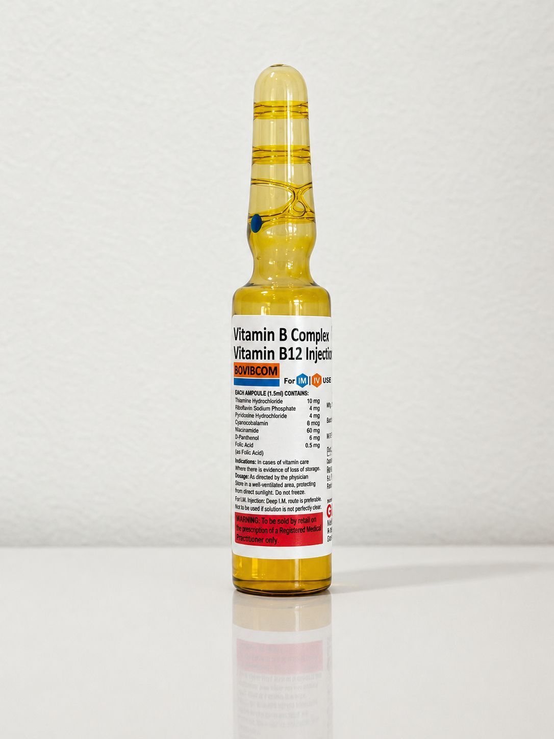 Yellow medicine ampoule with white label, standing upright on a white surface.