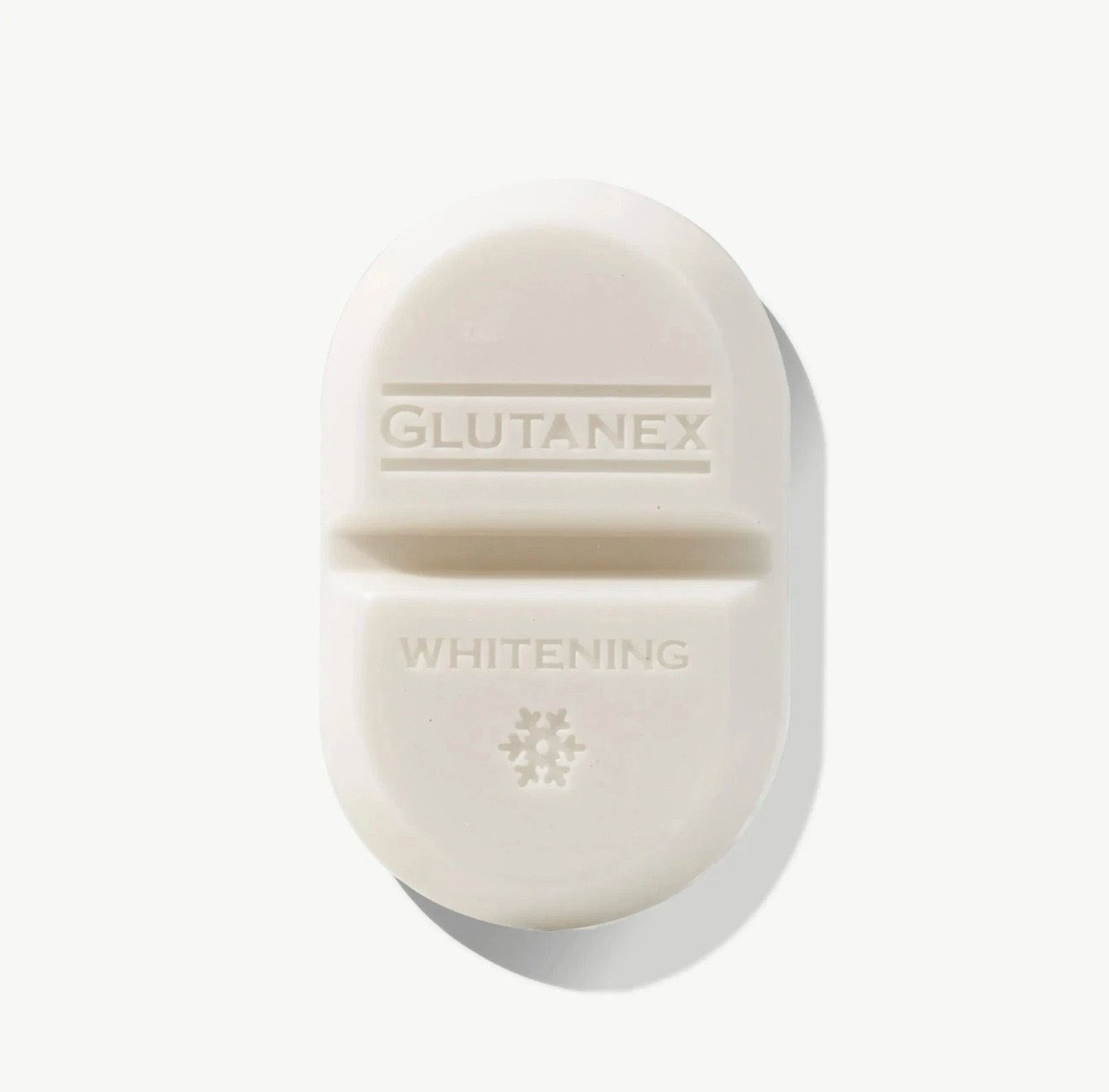 White GLUTANEX whitening tablet on a light background