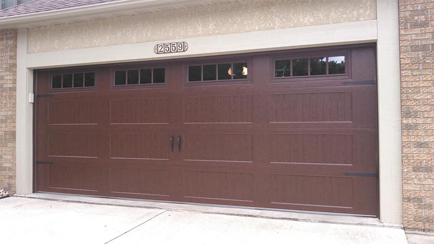 Brown garage door with windows above panels; house number 4532 above.