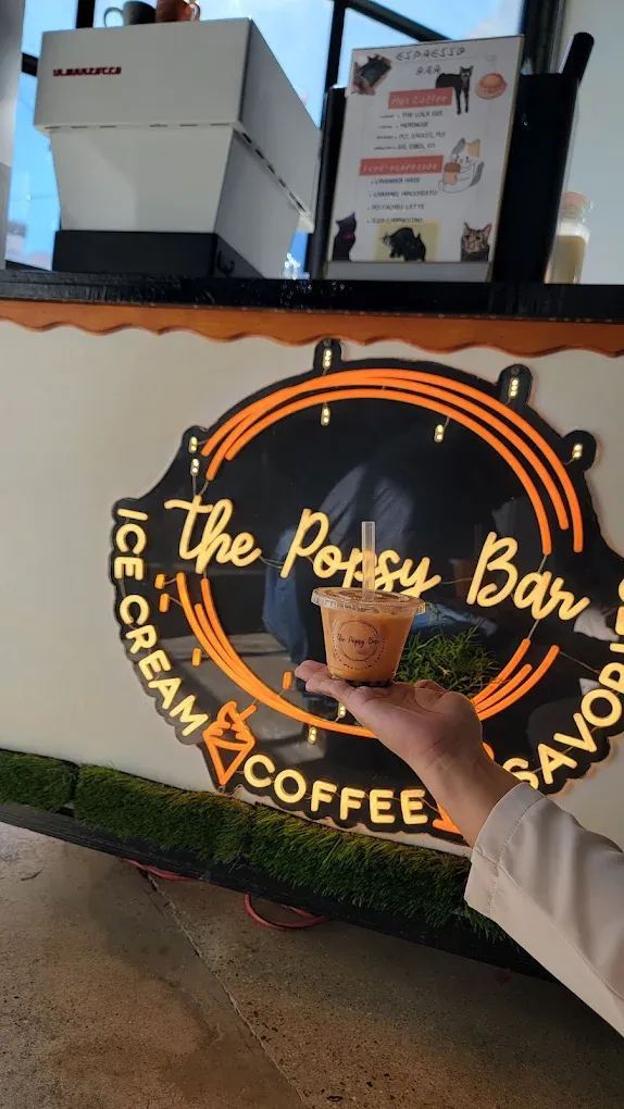 Person holding a beverage in front of 