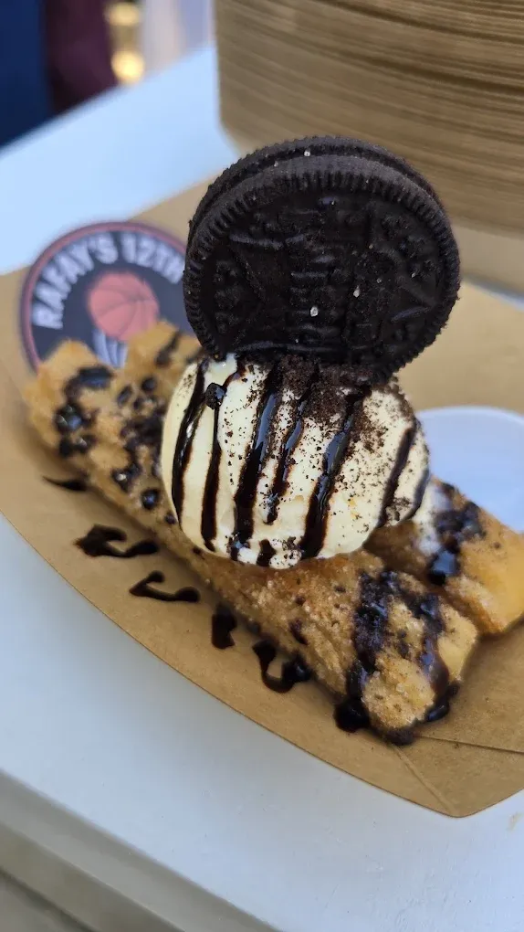 Two people stand by a coffee cart,