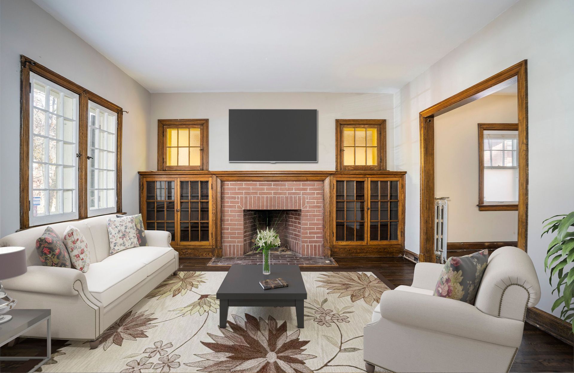 Bright living room with gray sectional, stone fireplace, wall TV, and large windows