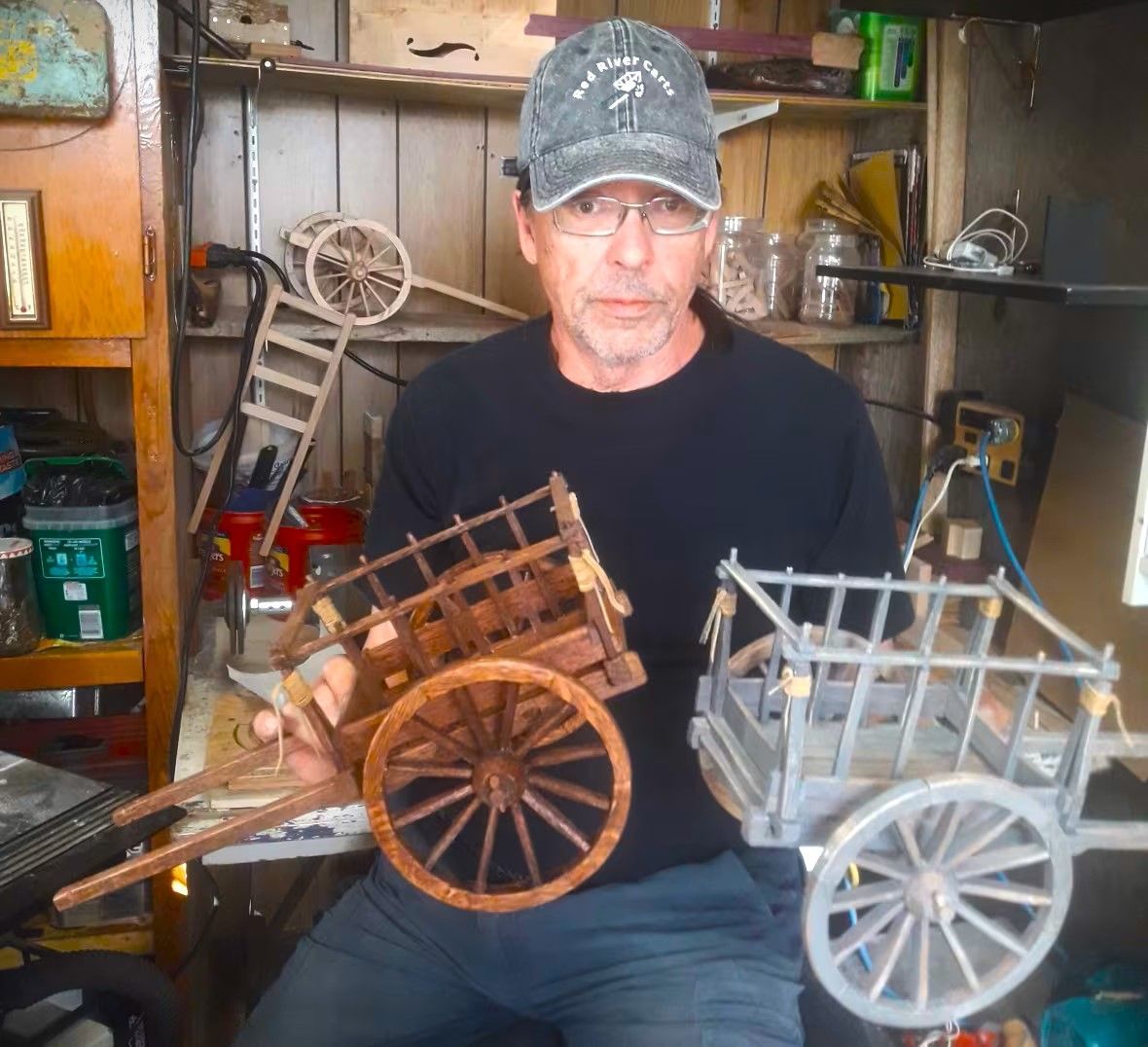 Garry Patterson in his shop displaying his handcrafted Red River Carts