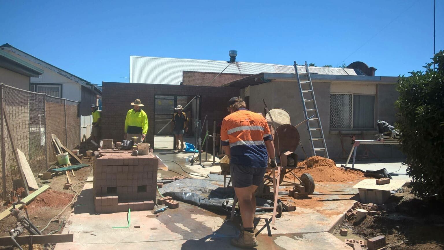 Construction Workers in High-visibility Gear Work on a Residential — Daniher Building Company in Flynn, ACT
